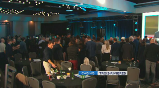 CAQ supporters watch the election results come in at the party's headquarters in Trois-Rivières, Que.