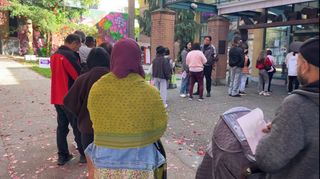 A line of voters is pictured outside the Collingwood Neighbourhood House on Vancouver election day.