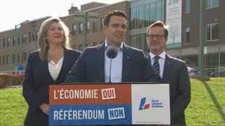 PLQ leader Charles Millard speaks at a podium with an anti-referendum slogan on Thursday, Oct. 1, 2026.