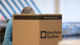 A woman votes at a polling station in Quebec City, Monday, October 3, 2022.