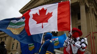 "Canada Guy" waves a Canadian flag during an Alberta independence rally at the Alberta legislature, in Edmonton on Saturday, Oct. 17, 2026. THE CANADIAN PRESS/Amanda May Erickson