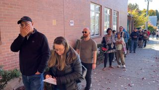 A line of voters is pictured outside the Collingwood Neighbourhood House on Vancouver election day.