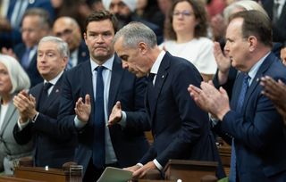 Prime Minister Mark Carney is applauded after delivering a statement about the incident at CFB Wainwright as he rises in the House of Commons in Ottawa, Monday, Oct. 19, 2026.