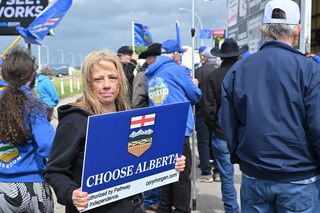 A demonstrator holds a Choose Alberta sign during an Alberta independence rally in Taber, Alta., on Sunday, June 28, 2026.