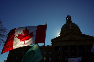 A Canadian flag flies in front of the of the Alberta Legislature in Edmonton, on Sunday, Oct, 18, 2026.