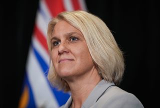 MLA Elenore Sturko listens during a news conference after former BC United MLA Teresa Wat joined the Conservatives, in Richmond, B.C., on Tuesday, July 30, 2024. THE CANADIAN PRESS/Darryl Dyck