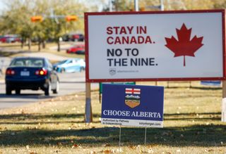 Competing referendum signs line a boulevard in Calgary, Thursday, Oct. 15, 2026. THE CANADIAN PRESS/Jeff McIntosh
