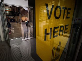 A person exits a polling station after voting in Toronto's municipal election, on Monday, Oct. 26, 2026.