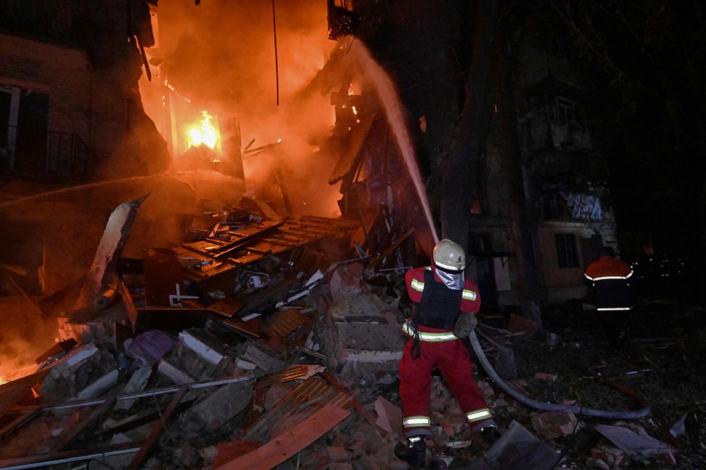 Ukrainische Feuerwehrleute löschen einen Brand nach einem russischen Drohnenangriff auf ein mehrstöckiges Wohngebäude in Charkiw.